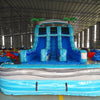 Front view of the 15ft Bahama Blast water slide showing three blue sliding lanes, central climbing section, inflatable palm trees on top, and a large splash pool area at the base.