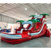 Side view of Crimson Bay inflatable water slide displaying full length with red sliding lane, palm tree accents, and spacious splash pool in indoor facility.