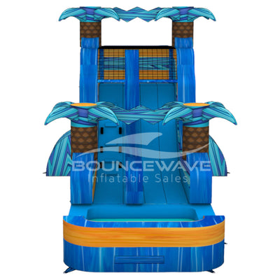 15ft Flashpoint Falls Commercial Single Lane Inflatable Water Slide featuring tropical palm trees, blue curved slide, and orange inflatable base with extended splash pool on white background
