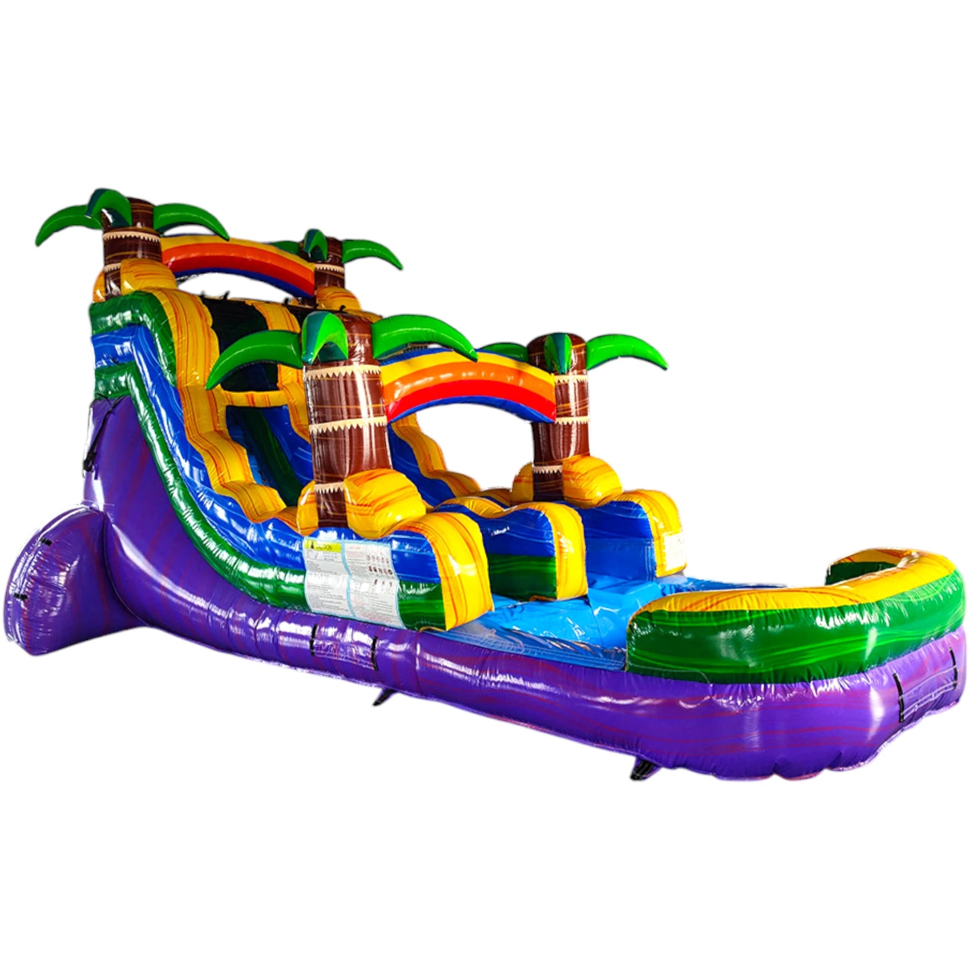 Side view of Goombay Splash inflatable water slide showing full length with blue sliding lane, palm trees, and extended splash pool in warehouse environment.