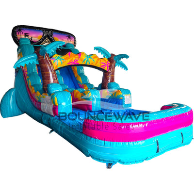 Side view of Island Flow single lane water slide featuring turquoise base, sunglasses-shaped top, palm tree decorations, and extended splash pool with pink rim.