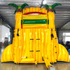 15ft Rasta Splash Commercial Single Lane Inflatable Water Slide featuring tropical-themed design with palm trees, yellow structure, red slide, and inflatable pool area in warehouse setting
