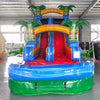 Front view of Reggae Rush single lane water slide in indoor facility, showcasing its height, yellow sliding lane, palm tree decorations, and extended blue and green splash pool area with tiki-inspired elements.