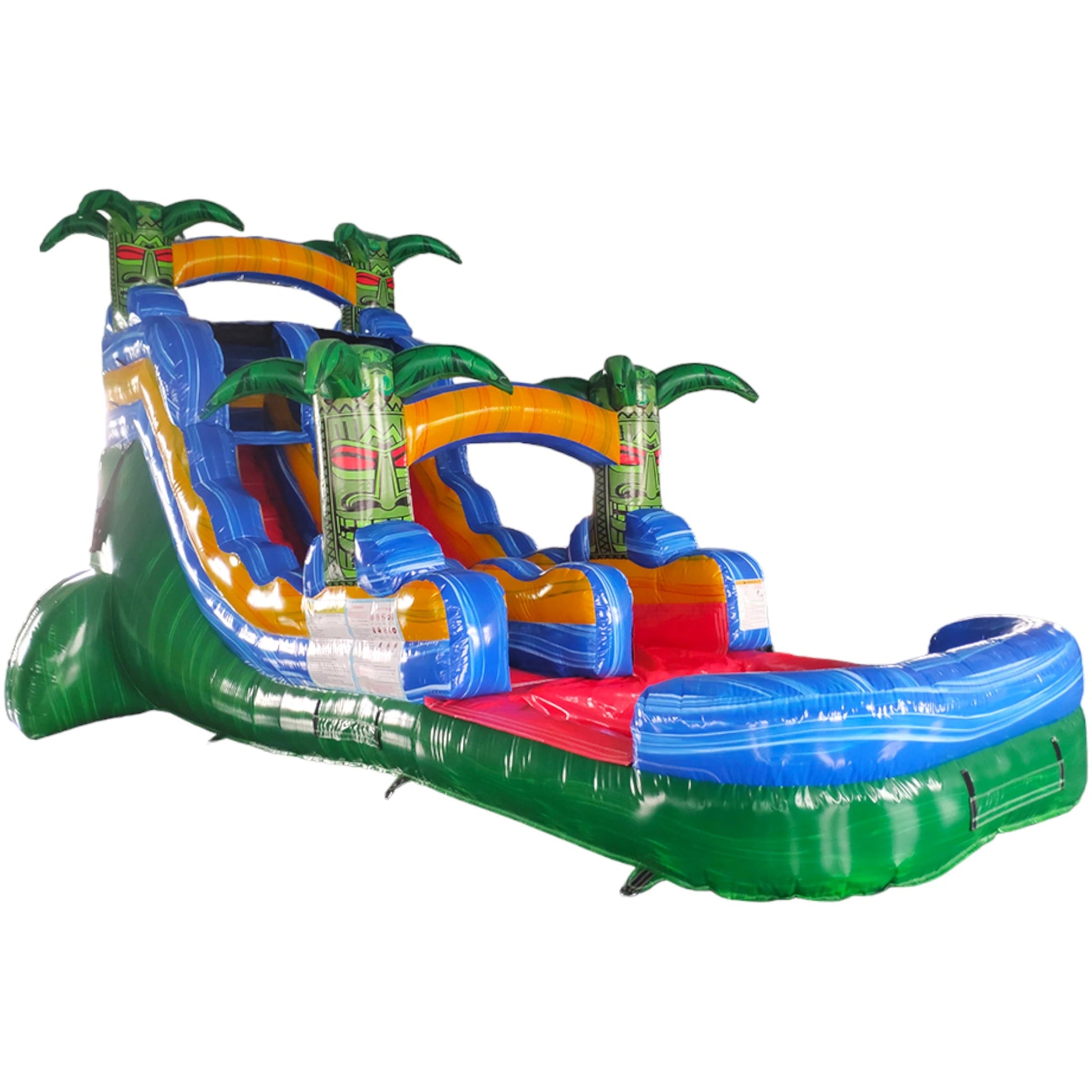 Large tropical-themed inflatable water slide featuring a single sliding lane, palm tree decorations, and an extended splash pool with vibrant blue, yellow, and green colors in indoor warehouse setting.