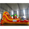  Inflatable tropical-themed water slide with yellow and red curves, palm tree decorations, and a single lane, set up in a large indoor warehouse