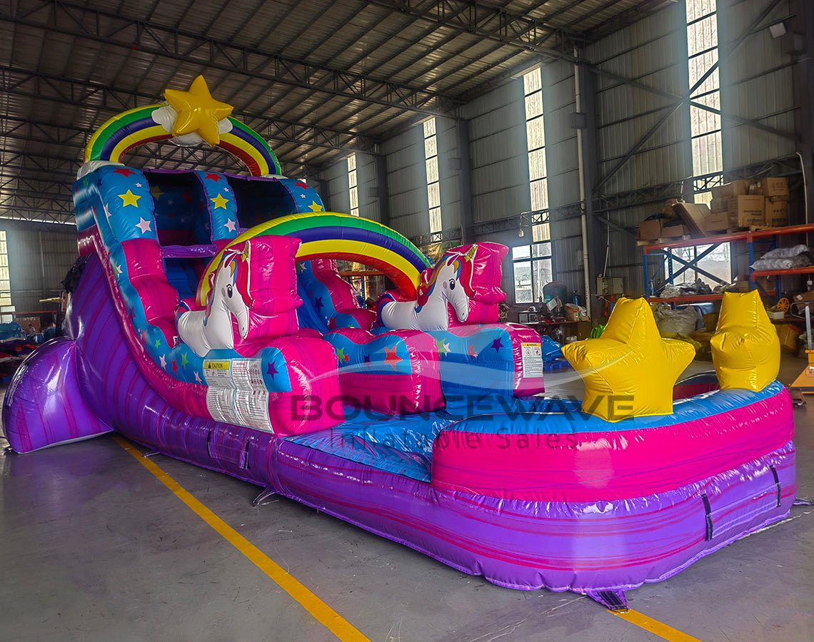 Close-up view of Unicorn Splash inflatable water slide displaying vibrant colors, rainbow designs, unicorn decorations, and star-shaped pool floats in splash area.