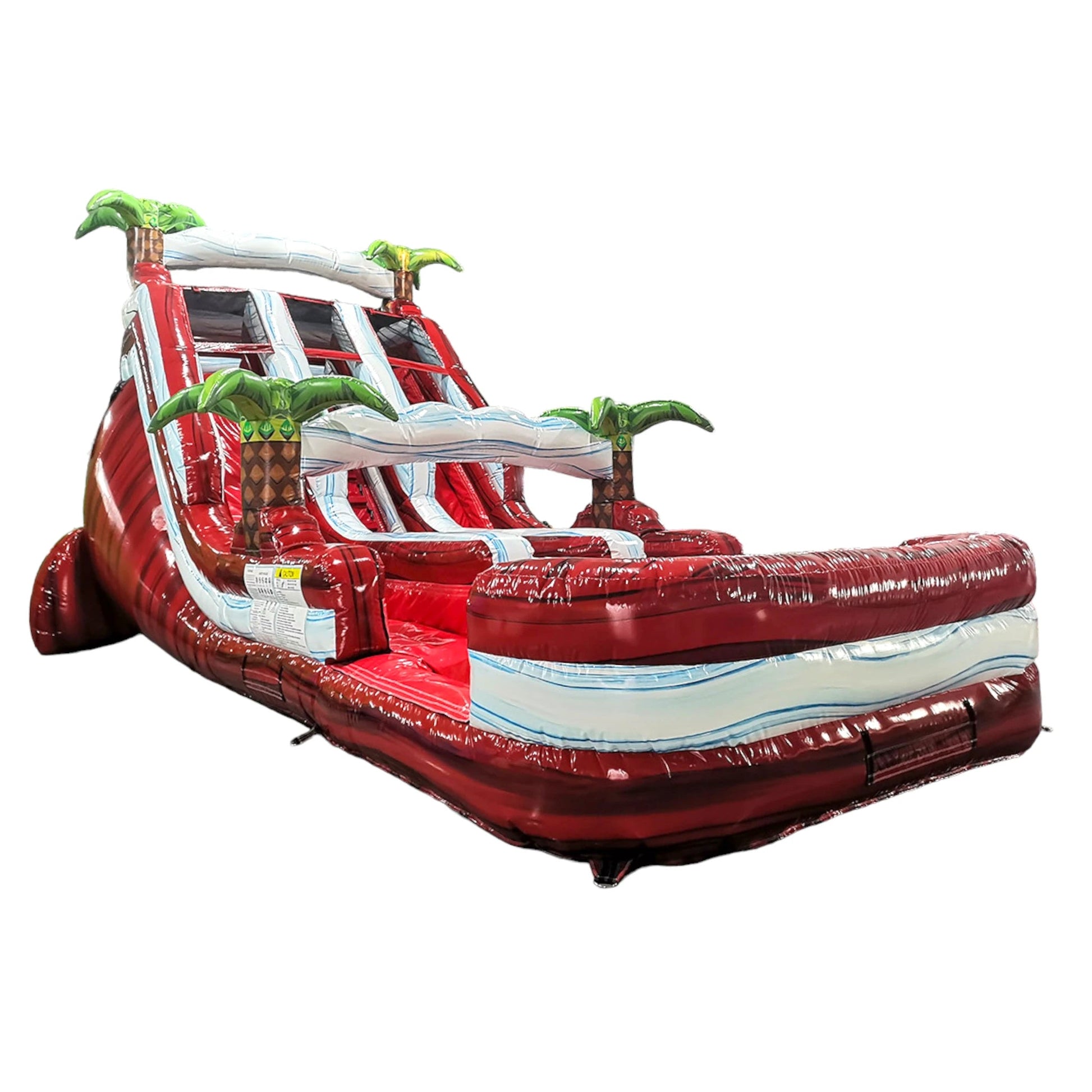 Side view of 18ft Crimson Bay Center Climb water slide displaying vibrant red base, blue wave patterns, inflatable palm trees, and large splash pool area against a white background.