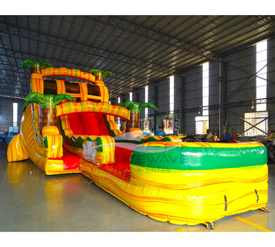 Side view of Rasta Splash hybrid water slide showing full length with dual sliding lanes, palm tree accents, and large splash area with yellow, green, and red colors.