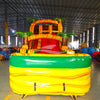 Front view of Rasta Splash inflatable water slide displaying vibrant yellow, green, and red design with palm tree decorations and spacious splash pool in indoor facility.