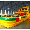 Angled view of Rasta Splash hybrid water slide in indoor warehouse, showcasing its height, dual lanes, tropical theme with palm trees, and extended yellow and green splash pool.