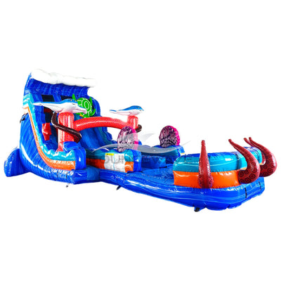 Large ocean-themed inflatable water slide with blue base, featuring dual lanes, shark and fish decorations, and an extended splash pool with octopus tentacles.