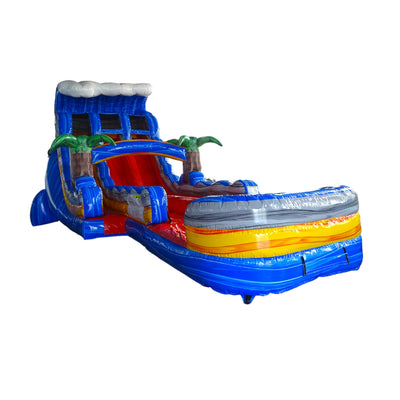 Large ocean-themed inflatable water slide with blue base, featuring dual lanes, shark and dolphin decorations, and an extended splash pool with octopus tentacles in indoor warehouse setting.