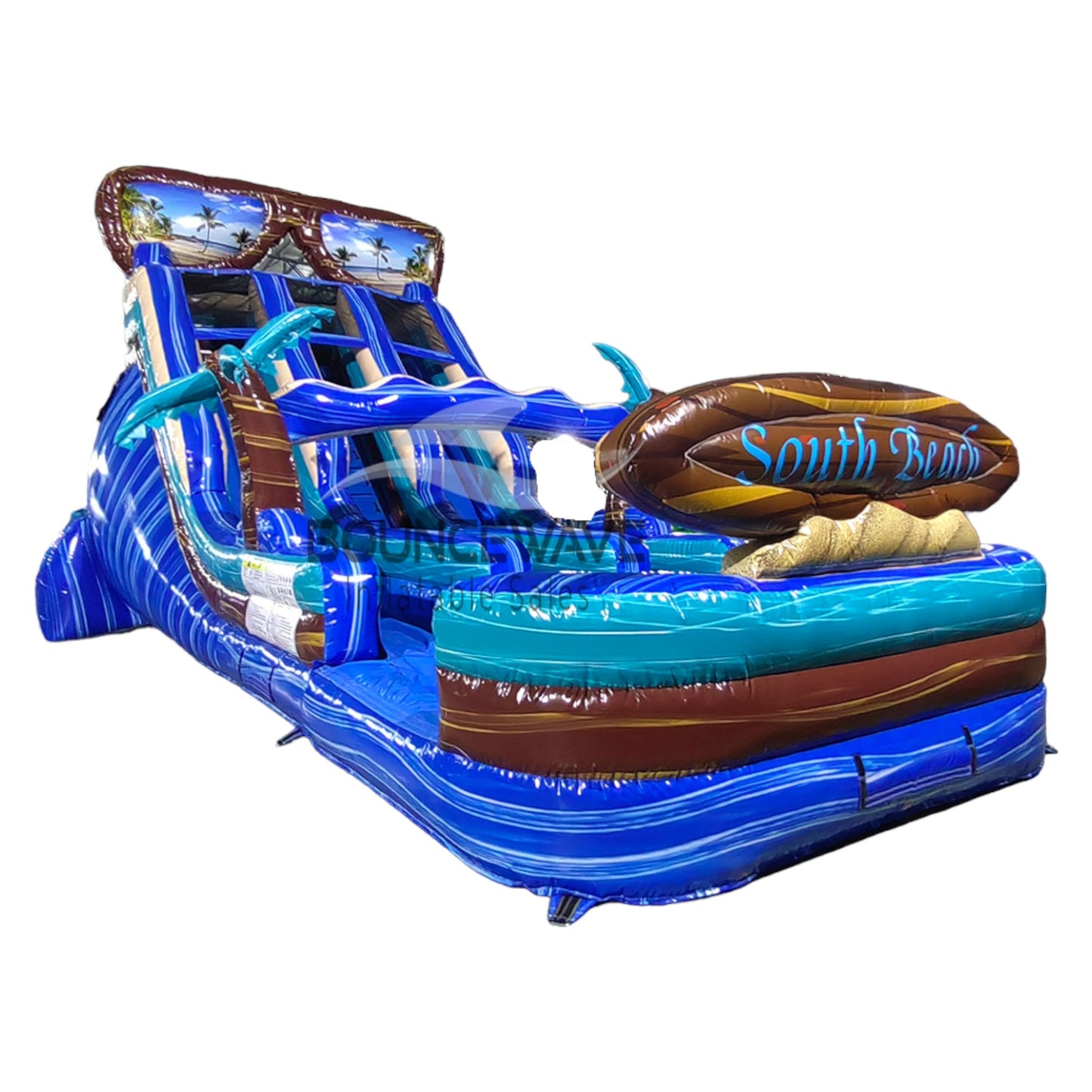 Side view of 18ft South Beach Center Climb water slide showing vibrant blue, brown, and turquoise colors, inflatable palm trees, and a large splash pool area with "BOUNCEWAVE" branding, isolated on a white background.