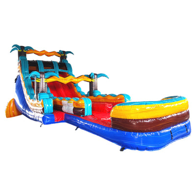 Large tropical-themed inflatable water slide featuring vibrant colors, dual sliding lanes, palm tree decorations, and an extended splash pool with wave-like design and multiple inflatable barriers.