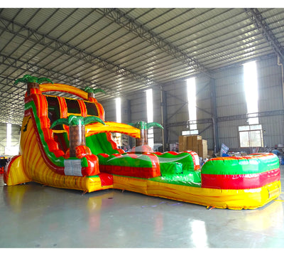 Side view of Tropical Inferno hybrid water slide showing full length with dual sliding lanes, palm trees, and large splash area with yellow, red, and green colors.