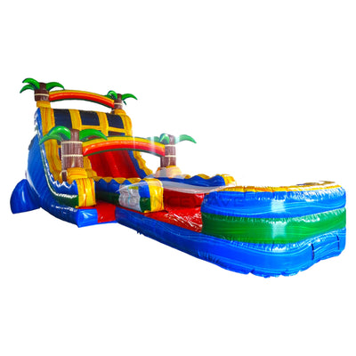 Large tropical-themed inflatable water slide featuring palm tree decorations, dual sliding lanes, and an extended splash pool with vibrant blue, yellow, and red colors.