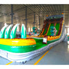 Side view of 20ft Dino Dive Hybrid DL water slide showing vibrant green colors, inflatable dinosaur figures, and a large splash pool area. The slide features both open and enclosed sliding sections, displayed in an indoor facility with other inflatables visible.