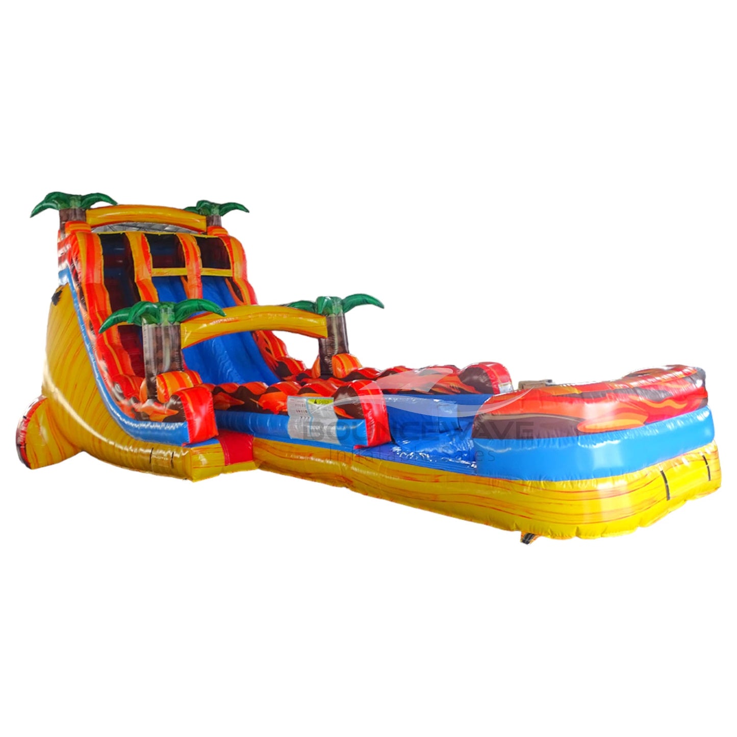 Large inflatable water slide with tropical theme, featuring vibrant red and yellow colors, palm tree decorations, and a spacious splash pool area. The slide combines open and enclosed sections, set up in an indoor warehouse with metal roofing visible.