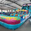 20ft Island Flow Dual Lane Center Climb Inflatable Water Slide side view showcasing vibrant colors, dual blue slides, inflatable palm trees, and extended splash pool
