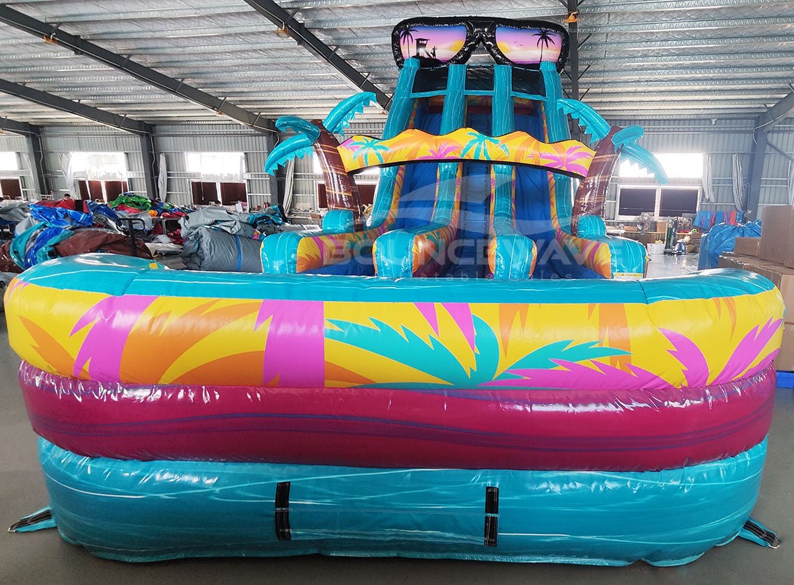 20ft Island Flow Dual Lane Center Climb Inflatable Water Slide front view displaying sunglasses design, colorful tropical motif, and dual curved water slides
