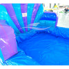 Large inflatable water slide with ocean theme, featuring blue and purple colors, shell-shaped top, and mermaid decorations. The slide has both open and enclosed sections, a spacious splash pool area, and is set up in an indoor warehouse with metal roofing visible.