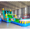 Side angle view of 20ft Radioactive Run Hybrid DL water slide featuring bright green and blue colors, caution stripe patterns, and a large splash pool area. The slide is set up in an indoor facility with metal roofing, disco balls, and other inflatables visible in the background.