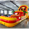 Wide-angle view of 20ft Summer Sizzler Hybrid DL water slide featuring yellow and red colors, inflatable palm trees, sun-shaped top, and a large splash pool area. The slide is set up in an indoor facility with metal roofing, bright lighting, and other inflatable products visible in the background.