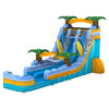 Side view of 20ft Surfs Up Hybrid DL water slide showing vibrant blue colors, inflatable palm trees, surfboard decorations, and a large splash pool area. The slide features both open and enclosed sliding sections, displayed in an indoor facility with other inflatables visible.