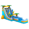 Large inflatable water slide with tropical beach theme, featuring blue sliding lanes, palm tree decorations, and surfboard designs. The slide has multiple lanes, a spacious splash pool area, and combines open and enclosed sections, set up in an indoor warehouse with metal roofing visible.