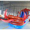 Side view of 20ft Tentacle Typhoon Hybrid DL water slide showing red, brown, and blue design, with large octopus tentacles wrapping around the structure. The slide features both open and enclosed sliding sections, displayed in an indoor facility with other inflatables visible.