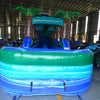 24ft Trop Wave DL 2pc Commercial Water Slide with Inflatable Slip & Slide featuring tropical palm trees, blue slide, and extended slip and slide in warehouse setting
