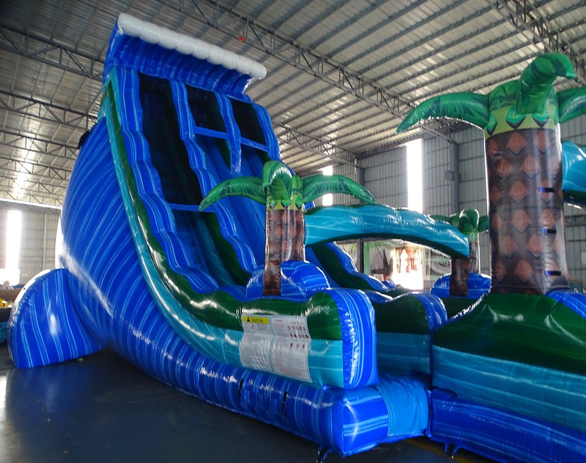 24ft Trop Wave DL 2pc Commercial Water Slide with Inflatable Slip & Slide displaying tall blue slide, tropical theme with palm trees, and expansive slip and slide
