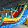 24ft Tropic Shock Dual Lane Commercial Water Slide with Inflatable Slip & Slide side angle displaying curved blue slides, tropical theme, and long water play area in indoor facility
