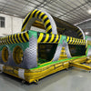 Three-quarter view of 46ft Hazardous Commercial Hybrid Inflatable Obstacle Course in a large warehouse. The structure features yellow and black hazard stripes, circular openings, and various obstacles. The warehouse setting shows metal roofing, support beams, and other inflatable products, demonstrating its commercial application.