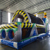 cross rear view of 53ft XL Radioactive Run Commercial Hybrid Inflatable Obstacle Course showing inflatable obstacles. The image displays yellow and gray cylindrical barriers, green flooring, and yellow and black striped walls. Various inflatable obstacles are visible, including tunnels and climbing areas, demonstrating the course's challenging layout.