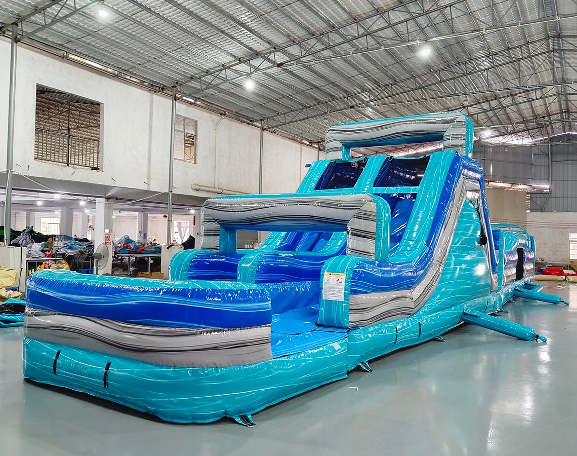 62ft Bahama 2-Piece Wet/Dry Inflatable Obstacle Course side view showcasing long blue structure with wave designs, various challenges, and inflatable pool area
