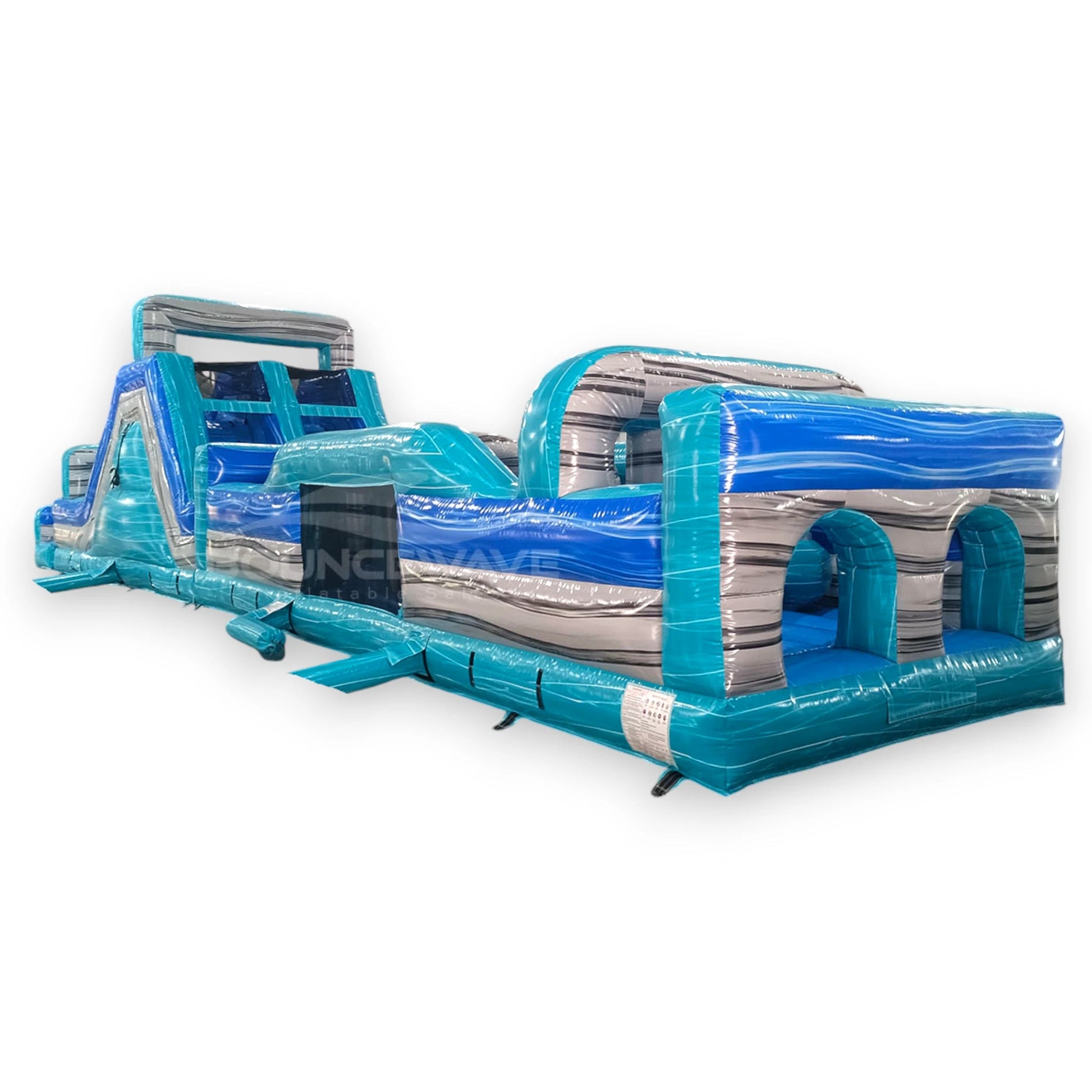 62ft Bahama 2-Piece Wet/Dry Inflatable Obstacle Course featuring blue and turquoise design with wave patterns, multiple obstacles, and slide in warehouse setting
