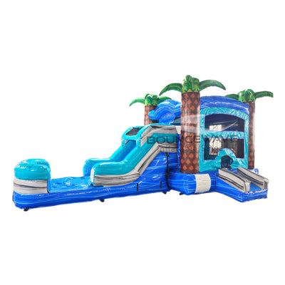 Inflatable tropical-themed combo featuring a bounce house with palm tree decorations, attached slide, and splash pool. The structure has vibrant blue, turquoise, and green colors with brown palm tree trunks. Set against a white background.