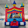 Carnival Commercial Grade Bounce House in warehouse setting, showcasing colorful castle design with mesh windows and inflatable columns
