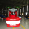 Large inflatable tropical-themed combo featuring a bounce house with palm tree decorations, attached slide, and splash pool. The structure has vibrant red and white colors with brown palm tree trunks. Set up in an indoor warehouse with metal roofing visible.