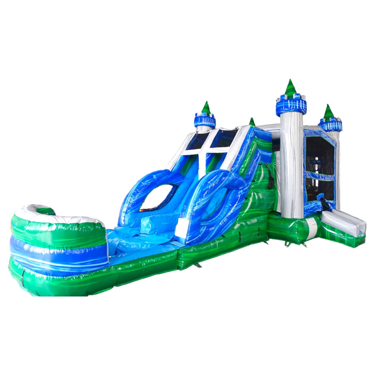 Side view of Euro Green Castle Dual Lane Commercial Inflatable Combo showcasing its full length. The inflatable features white castle towers with blue accents and green conical tops, dual blue slides, and a large circular splash pool. The bounce house area has mesh windows for visibility. Set against a white background, highlighting its design for commercial wet/dry use.