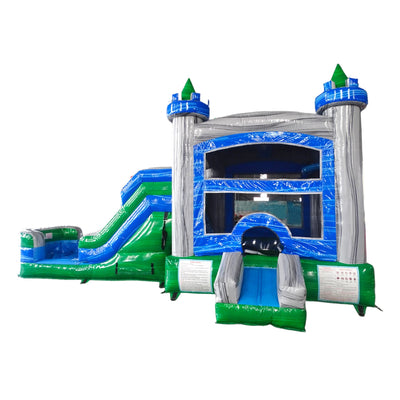 Large inflatable castle-themed combo featuring a bounce house with blue and silver walls, green turrets, and multicolored accents. Includes a green slide, blue obstacles, and a splash pool area. Set up against a white background, showcasing its multi-functional wet/dry design.