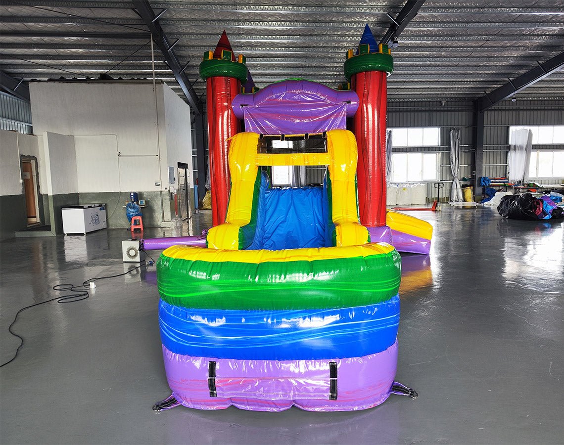 Front view of Euro Marble Econo Combo showing vibrant red, green, yellow, and purple colors. Features a bounce house with castle-like design, attached slide, and splash pool. Displayed in an indoor facility with various equipment visible in the background.