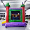 Colorful inflatable castle-themed combo featuring a bounce house with red turrets, green roof, and purple base. Includes a yellow slide and multicolored splash pool. Set up in an indoor warehouse with metal roofing visible.