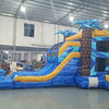 Flashpoint Dual Lane Commercial Inflatable Combo (Wet/Dry) showcasing blue and yellow design with palm tree pillars, dual slides, and large splash area in warehouse setting
