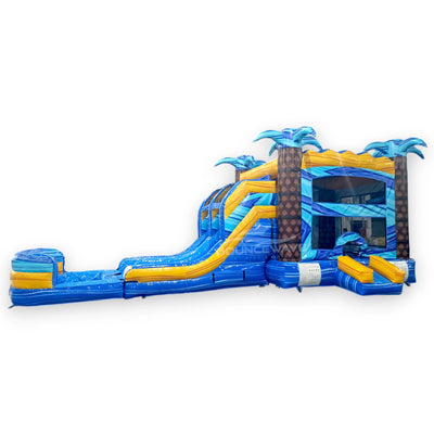 Flashpoint Dual Lane Commercial Inflatable Combo (Wet/Dry) featuring tropical theme with palm trees, dual blue slides, yellow accents, and extended splash pool on white background
