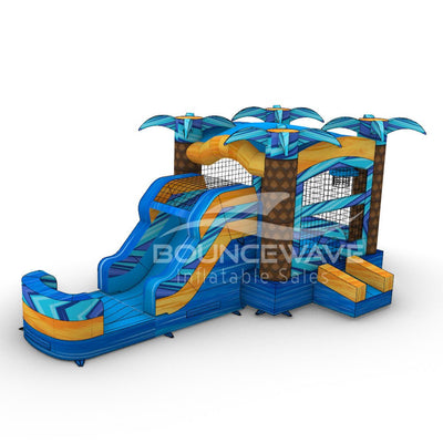 Side view of Flashpoint Falls Commercial Econo Inflatable Combo showing bright blue, yellow, and orange design with inflatable palm trees, curved slide, and large splash pool area. The combo includes a bounce house and is isolated on a white background.