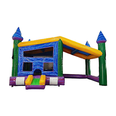 Side view of Goombay Commercial Grade Canopy Bounce House showcasing its blue inflatable frame with four tall pillars topped by white cylindrical turrets and blue conical roofs. The bounce area features yellow walls with mesh windows for visibility. A yellow canopy stretches across the top, providing shade. The structure is set up on a polished concrete floor in a warehouse setting with other inflatable products visible.