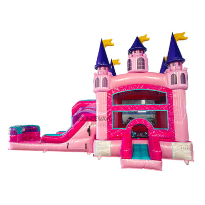 Large pink inflatable castle-themed combo featuring a bounce house with purple turrets and yellow flags. Includes a curved slide, splash pool, and multiple play areas. The structure has vibrant pink, purple, and teal colors with princess castle designs. Isolated on a white background.