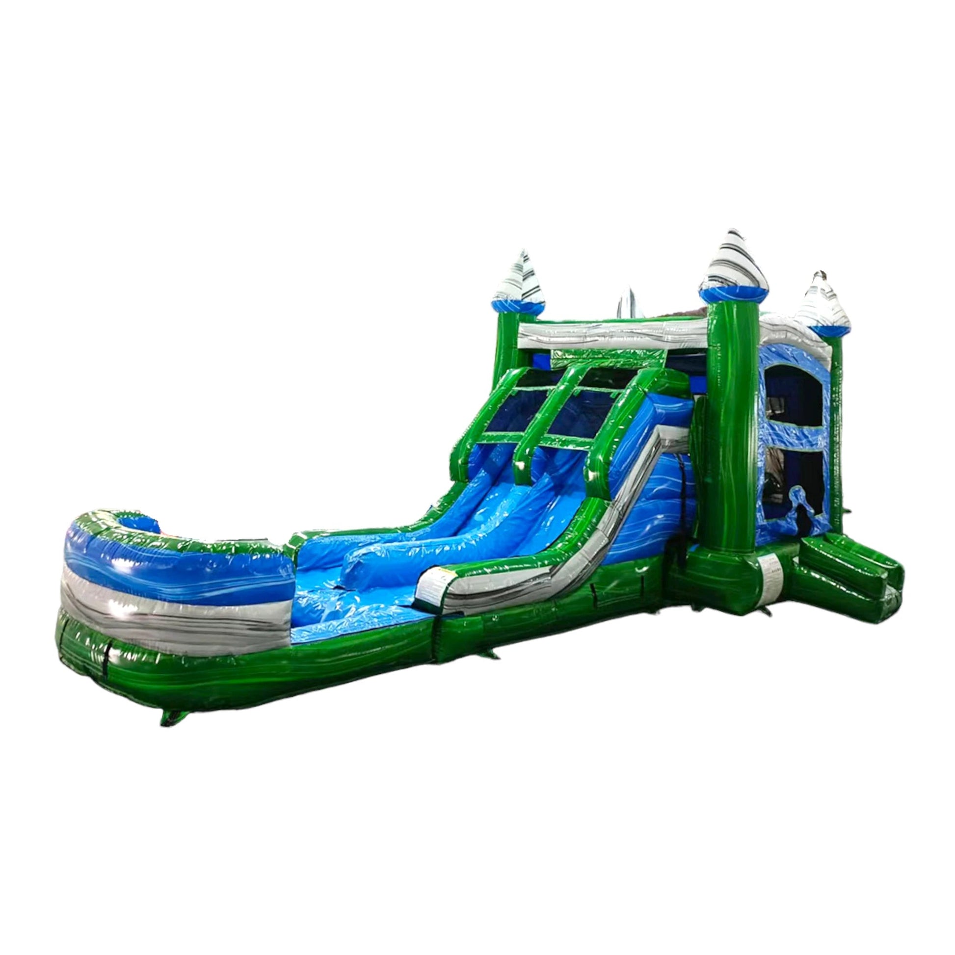 Side view of Green Gush Dual Lane Commercial Inflatable Combo isolated on a white background. The inflatable features green towers with blue and white striped tops, dual blue slides, a bounce house area, and a large splash pool. The structure showcases its vibrant green and blue color scheme and wet/dry functionality.